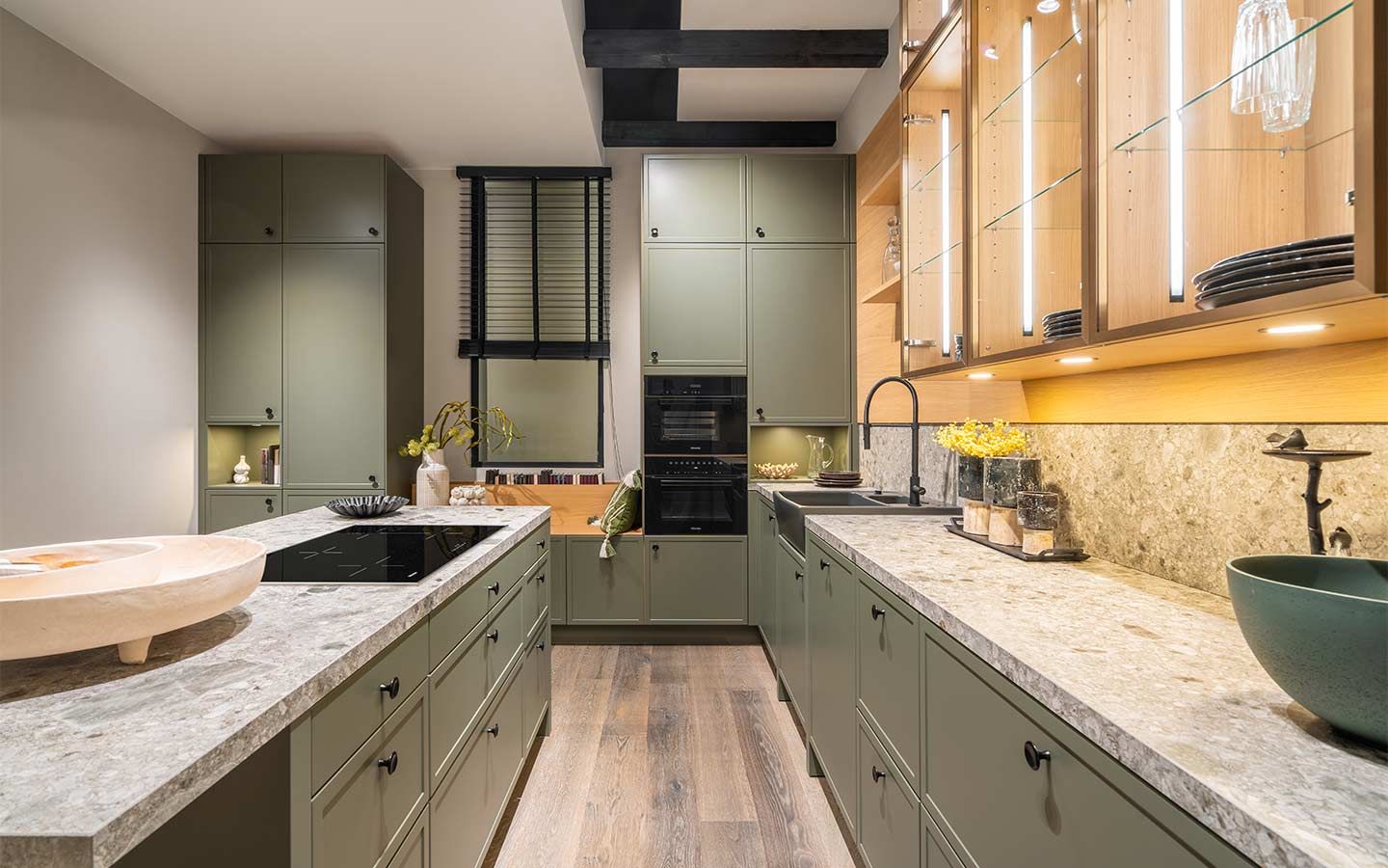 Olivgrüne Küche mit hellen Geschirrschrank Eine Olivgrüne Küche mit hellen, hölzernen Geschirrschrank mit Glastüren